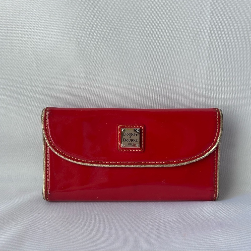 Dooney & Bourke patent continental Leather cluth with gold accents